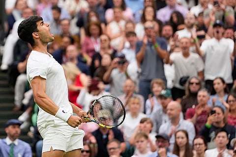 Carlos Alcaraz reacts after winning a point against Francis Tiafoe